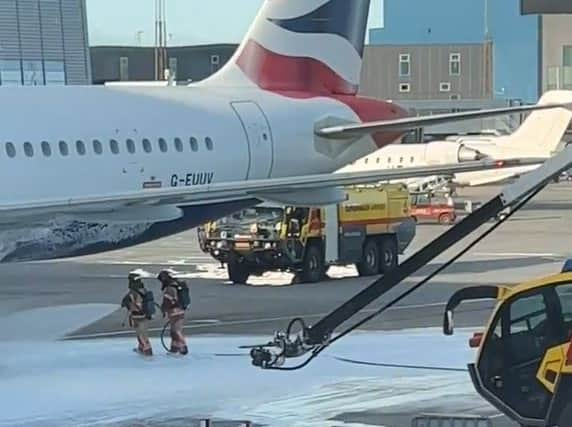 Dramatic scenes show firefighters tackling a fire on a British Airways passenger plane on Wednesday. Photo: SWNS