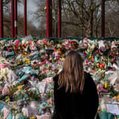 A woman places floral tributes at the bandstand in Clapham Common to Sarah Everard. Credit: Dan Kitwood/Getty Images