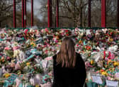 A woman places floral tributes at the bandstand in Clapham Common to Sarah Everard. Credit: Dan Kitwood/Getty Images