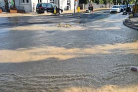 Dozens of firefighters are tackling a burst water main in Kingston-upon-Thames. Photo: LFB