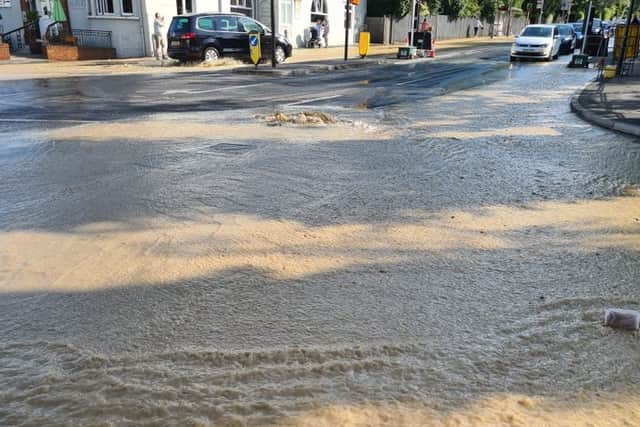 Dozens of firefighters are tackling a burst water main in Kingston-upon-Thames. Photo: LFB