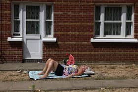A woman sunbathes in Hackney ahead of the Met Office’s extreme weather warning. Credit: Hollie Adams/Getty Images