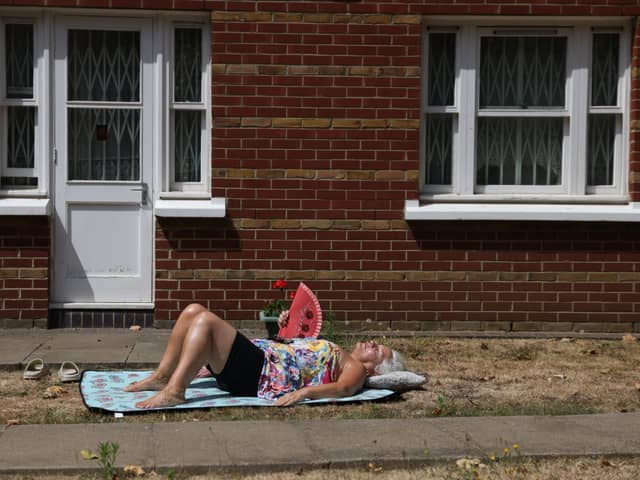 A woman sunbathes in Hackney ahead of the Met Office’s extreme weather warning. Credit: Hollie Adams/Getty Images