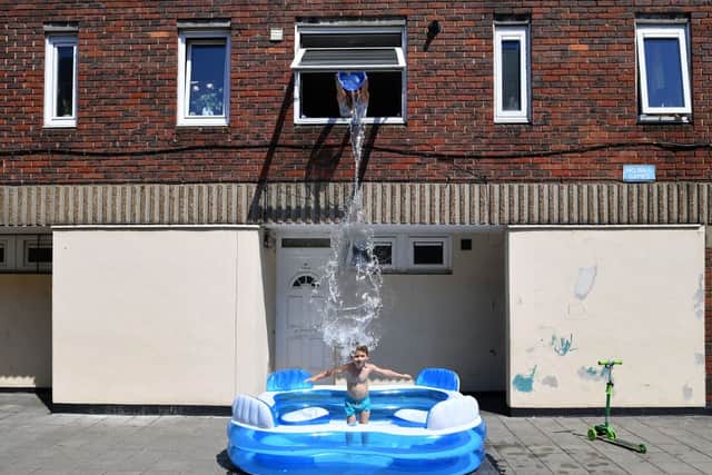A parent helps her child stay cool in Hackney. Credit: Getty Images