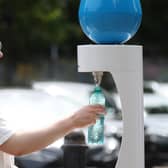 A woman refills a water bottle at Victoria Park on July 17, 2022 in London, as city dwellers found ways to stay cool. Photo: Getty