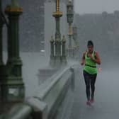 A female jogger crosses Westminster Bridge during a heavy thunderstorm on June 17, 2020 in London, England. (Photo by Dan Kitwood/Getty Images)