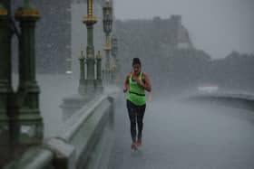 A female jogger crosses Westminster Bridge during a heavy thunderstorm on June 17, 2020 in London, England. (Photo by Dan Kitwood/Getty Images)