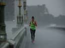 A female jogger crosses Westminster Bridge during a heavy thunderstorm on June 17, 2020 in London, England. (Photo by Dan Kitwood/Getty Images)