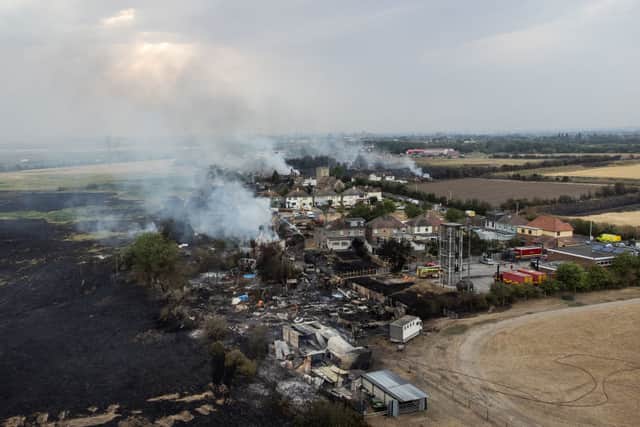 The blackened ground in Wennington, Havering, as the fire smoulders. Credit: Leon Neal/Getty Images