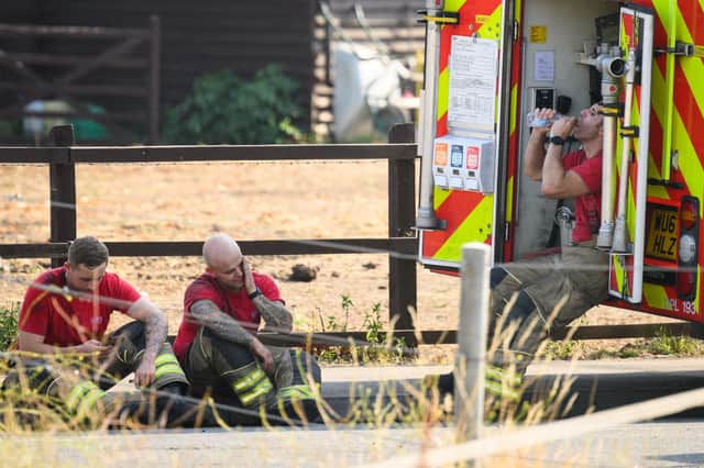 Brave firefighters rest after tackling the blaze in Wennington. Credit: Leon Neal/Getty Images