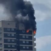 A fire has broken out in a high rise block in North Woolwich and a neighbouring patch of grass. Credit: Stevo