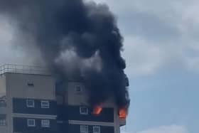 A fire has broken out in a high rise block in North Woolwich and a neighbouring patch of grass. Credit: Stevo