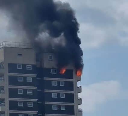A fire has broken out in a high rise block in North Woolwich and a neighbouring patch of grass. Credit: Stevo