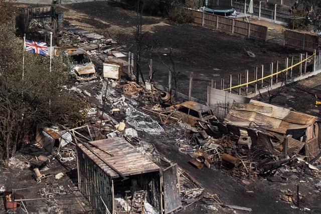 A Union Jack flag flies amongst the the rubble and destruction in Wennington, Havering. Credit: Leon Neal/Getty Images