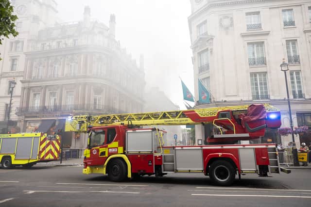 Firefighters attend a burning building in London’s Trafalgar Square on July 12, 2022