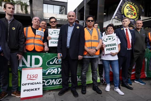 A picket line is joined by Mick Lynch, Secretary-General of the National Union of Rail, Maritime and Transport Workers, (centre)  Euston station on July 27, 2022 in London, United Kingdom