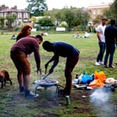 People cook on a barbeque in London Fields. Photo: TOLGA AKMEN/AFP via Getty Images