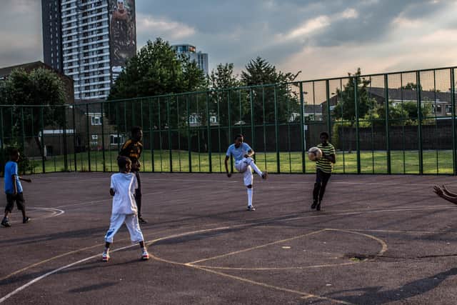 Children play football on the periphery of the Olympic Park in Stratford. Photo: Daniel Berehulak/Getty Images