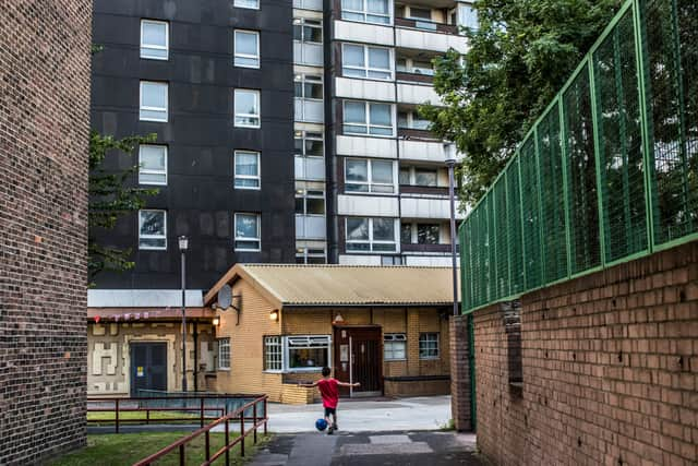 A boy kicks a football at an estate in Stratford. Photo :Daniel Berehulak/Getty Images