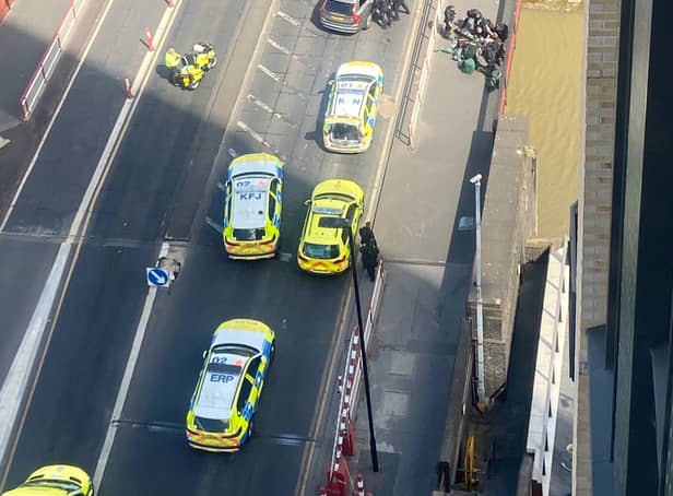 <p>Armed police and paramedics in Creek Road, Greenwich, after police shot a man who was reportedly brandishing a gun. Credit: Gemma Rose</p>