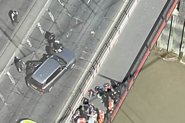 Police searched the grey car in Creek Road, Greenwich, while tending to the man who was shot by armed officers. Credit: Gemma Rose