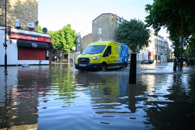 A private drain maintenance company vehicle negotiates the substantial flooding on roads near to the Arsenal Stadium. Photo: Getty