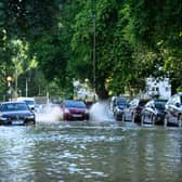 A car negotiates the substantial flooding on roads near to the Arsenal Stadium, following a rupture of water mains. Photo: Getty