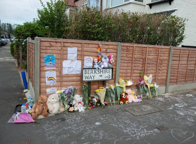 Flowers and tributes at street where a suspected gas explosion demolished a home yesterday killing a four-year-old girl. Credit: SWNS