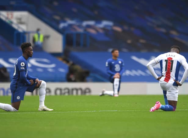 <p>Wilfried Zaha of Crystal Palace and Callum Hudson-Odoi of Chelsea take a knee in support of the black lives matter movement prior to the Premier League match between Chelsea and Crystal Palace (Photo by Neil Hall - Pool/Getty Images)</p>