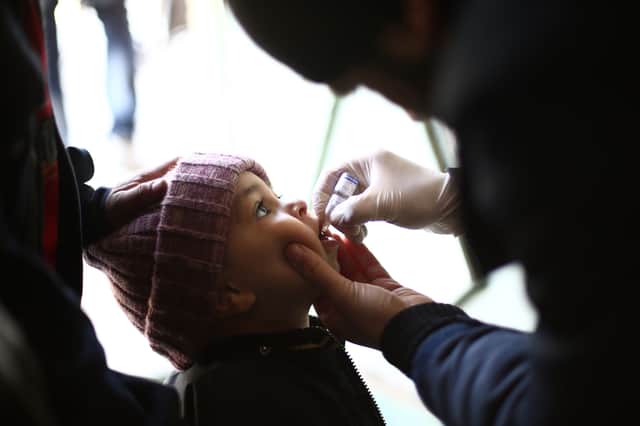 A Syrian child receives a vaccination against polio during a campaign organised by the Syrian Arab Red Crescent