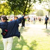 A festival reveler taking in the sights of Victoria Park and the sounds during All Points East 2021.