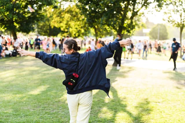 A festival reveler taking in the sights of Victoria Park and the sounds during All Points East 2021.