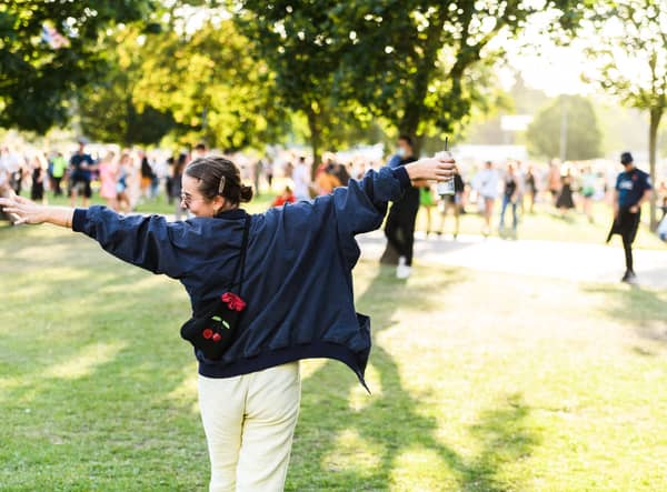 A festival reveler taking in the sights of Victoria Park and the sounds during All Points East 2021.