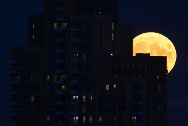Sky gazer Phil Vernon captured this beautiful shot of the supermoon rising above one of east London’s many skyscrapers. Credit: Phil Vernon