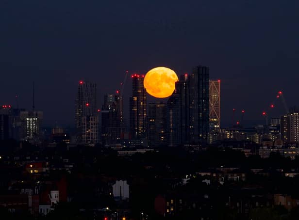 <p>Iuli Rukmin captured the supermoon setting behind London’s skyline from Hampstead Heath. Credit: Iuli Rumkin</p>