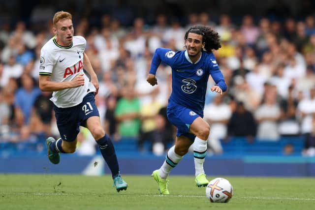 Marc Cucurella of Chelsea runs with the ball whilst under pressure from Dejan Kulusevski. Credit: Shaun Botterill/Getty Images
