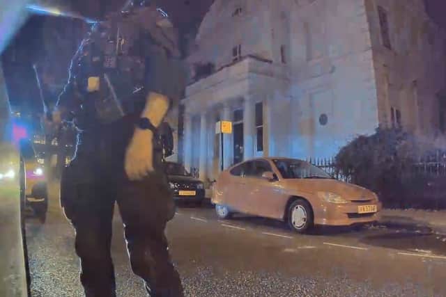 An armed police officer outside Ricardo dos Santos’ car. Credit: Ricardo dos Santos