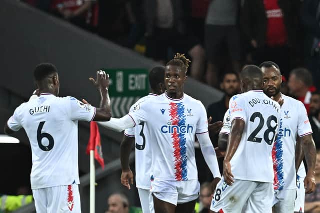 Crystal Palace's Ivorian striker Wilfried Zaha (C) celebrates after scoring his team first goal during the English Premier League football match 