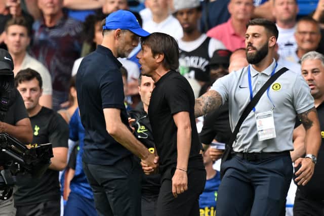  Tottenham Hotspur’s Italian head coach Antonio Conte (R) and Chelsea’s German head coach Thomas Tuchel . (Photo by GLYN KIRK/AFP via Getty Images)