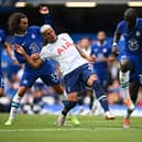 Richarlison of Tottenham Hotspur is challenged by Marc Cucurella and Kalidou Koulibaly of Chelsea. 