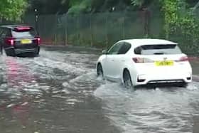 Torrential rain that forced commuters to wade through knee-deep water in London. Photo: SWNS