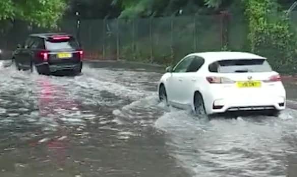 Torrential rain that forced commuters to wade through knee-deep water in London. Photo: SWNS