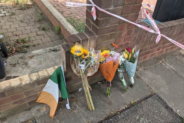 Flowers and an Irish flag left at the scene in Greenford where popular pensioner Thomas O’Halloran was fatally stabbed.