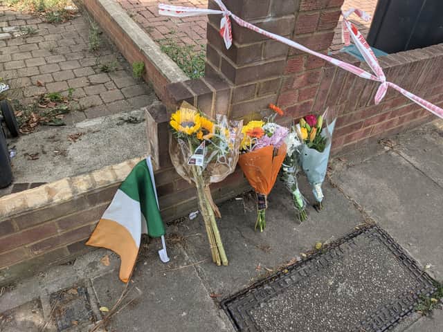 Flowers and an Irish flag left at the scene in Greenford where popular pensioner Thomas O’Halloran was fatally stabbed.