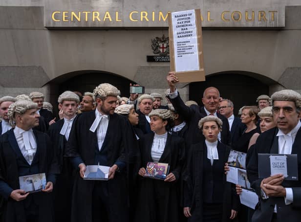<p>Defence barristers take part in a strike outside the Central Criminal Court, also known as the Old Bailey. Photo: Getty</p>