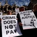 Senior criminal lawyers hold placards outside the Royal Courts of Justice, as they go on strike in a dispute over pay. Photo: Getty