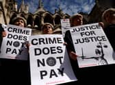 Senior criminal lawyers hold placards outside the Royal Courts of Justice, as they go on strike in a dispute over pay. Photo: Getty