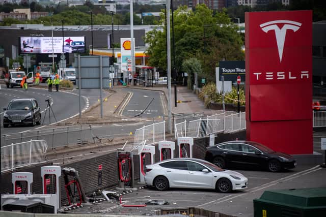 A Tesla car is loaded onto a truck at a Tesla garage after an incident at Park Royal tube station. Photo: Getty