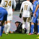 A ballboy (C) lies on the ground and reacts after a altercation with Chelsea's Belgium midfielder Eden Hazard  (Photo credit should read ANDREW YATES/AFP via Getty Images)