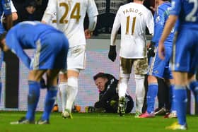 A ballboy (C) lies on the ground and reacts after a altercation with Chelsea's Belgium midfielder Eden Hazard  (Photo credit should read ANDREW YATES/AFP via Getty Images)